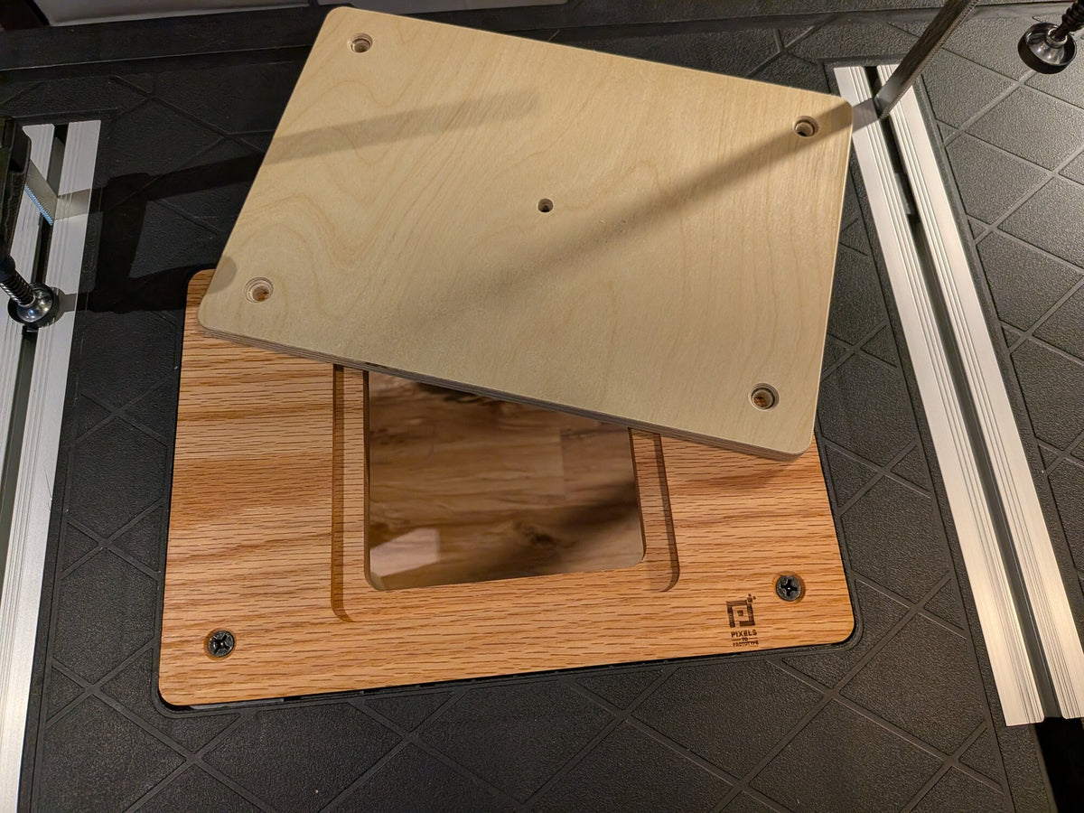 Birch router plate being lowered into the recess of the oak Ridgid router table adapter plate