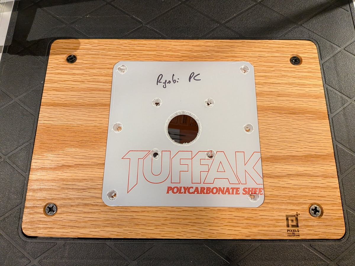 TUFFAK polycarbonate router plate seated in the oak Ridgid router table adapter plate