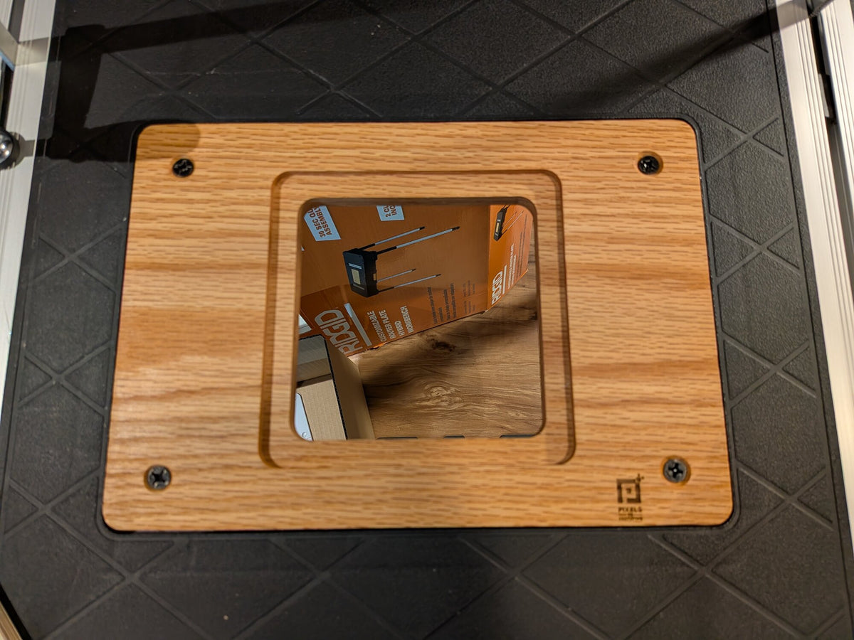 Oak Ridgid router table adapter plate showing the stepped recess and four mounting screws