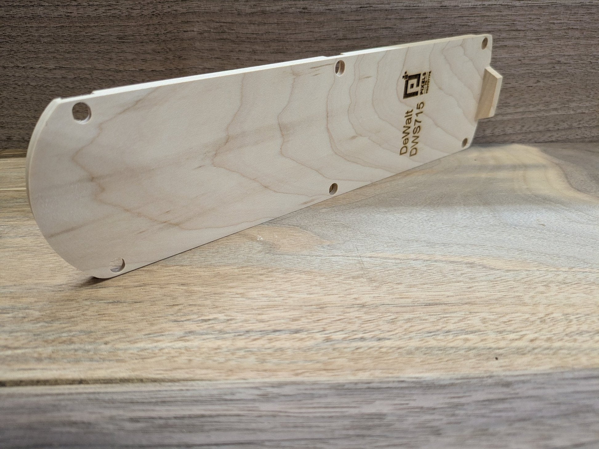 Edge profile of the DeWalt DWS715 hardwood zero clearance insert showing thickness and alignment tab