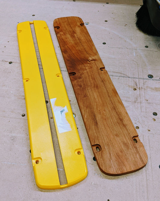 The factory yellow plastic insert beside a P2P hardwood zero clearance insert for the DeWalt DWS779 Type 20